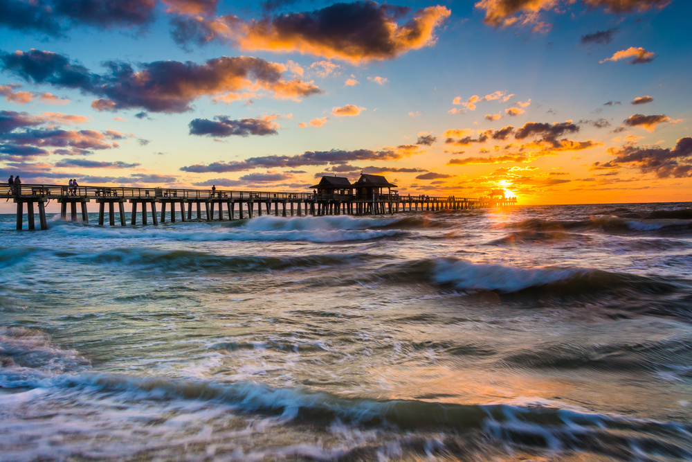 Sunset over the fishing pier and Gulf of Mexico in Naples, Florida. Sunset over the fishing pier and Gulf of Mexico in Naples, Florida.